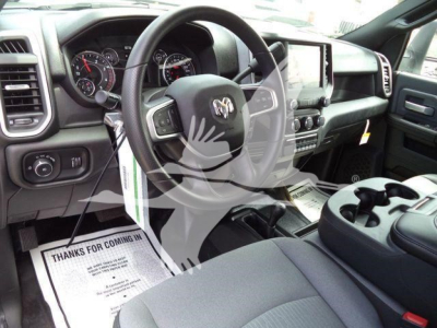 Ram 5500 cab interior showing steering wheel, center console, gauge cluster, and touchscreen display.