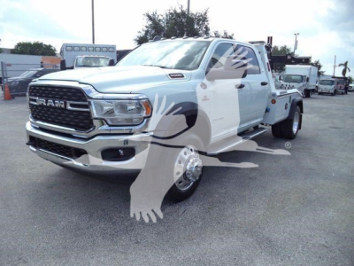 2024 Ram 5500 SLT pickup truck in white with chrome grille, dual rear wheels, and a winch category vehicle. Visible text includes RAM on grille and badge near hood.