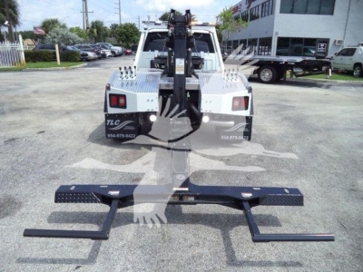 Ram 5500 tow truck rear view with winch and heavy-duty rails, loading platform visible, rear bumper and hydraulic winch in center.