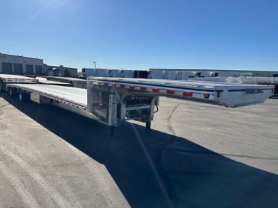 Mac drop deck trailer showing steel flatbed with extension and undercarriage components visible