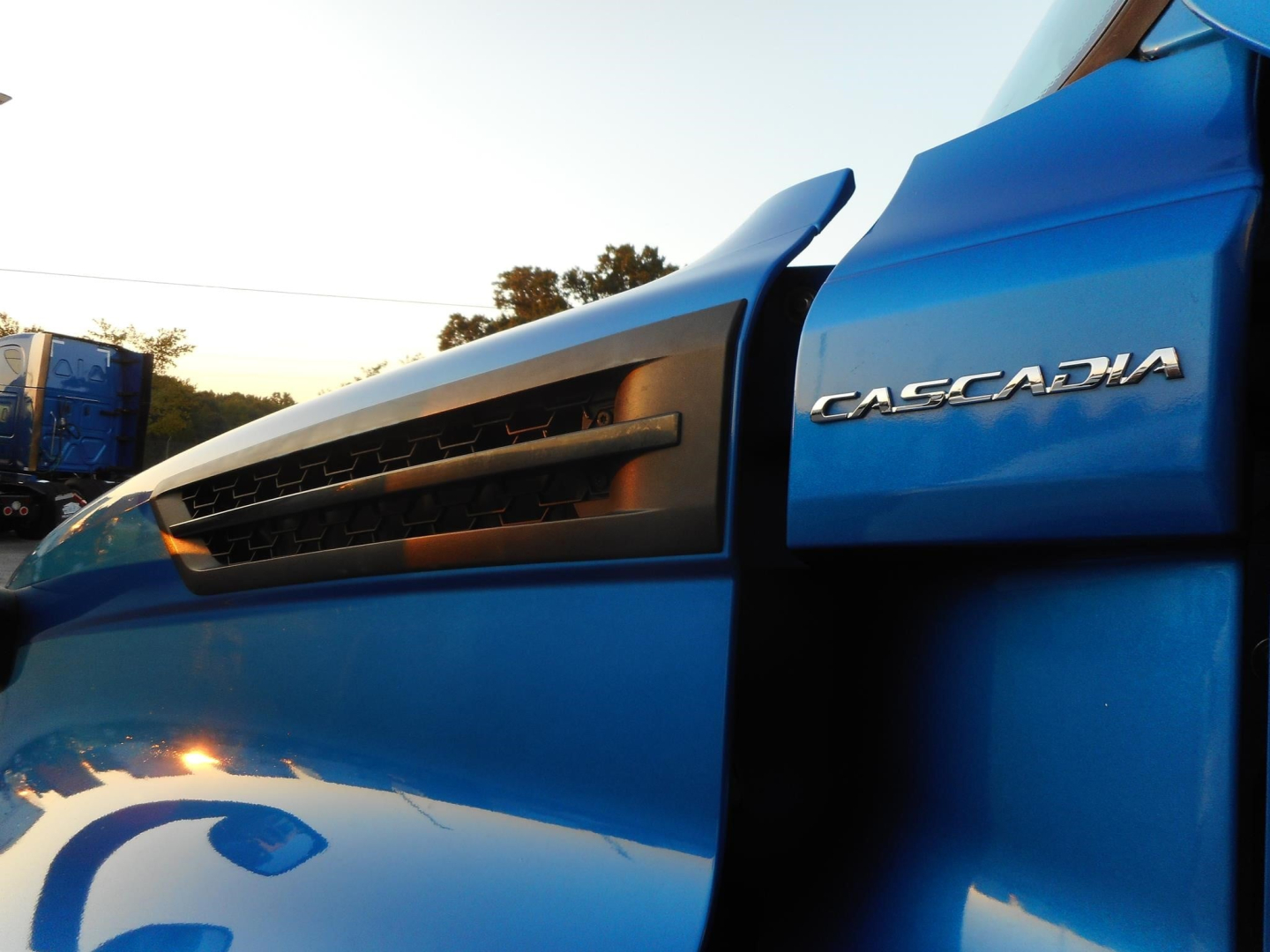 Freightliner Cascadia 126 truck side showing Cascadia badge and grille.
