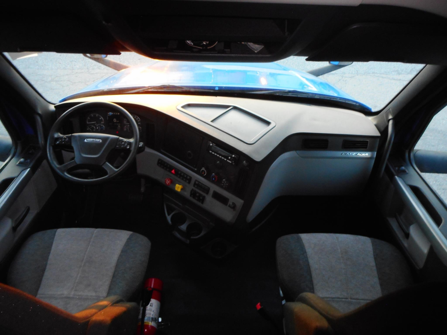 Truck cab interior view of 2022 Freightliner Cascadia 126 with steering wheel, dashboard, and seats visible.