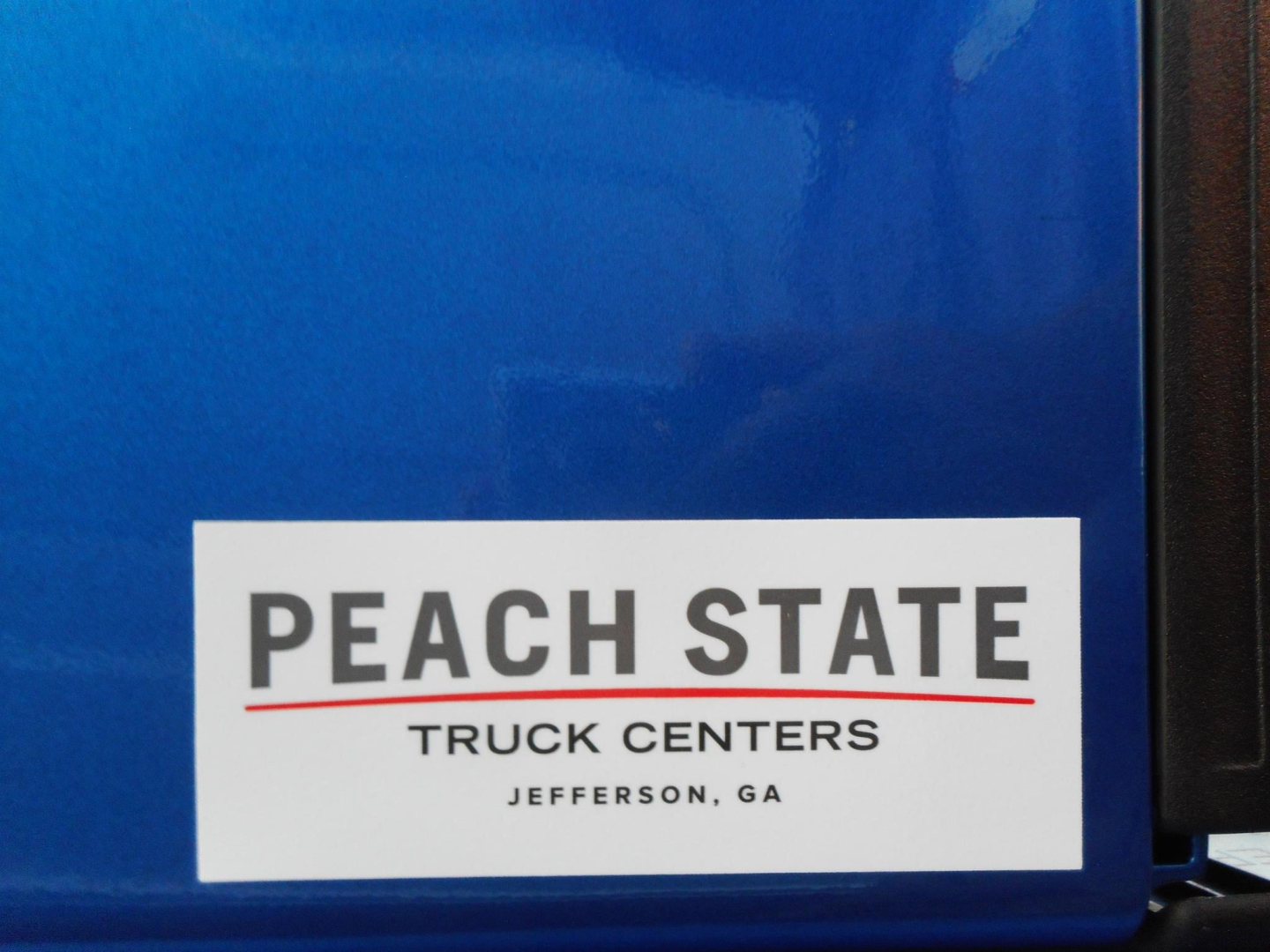 Sticker on blue truck door showing 'PEACH STATE TRUCK CENTERS JEFFERSON, GA'