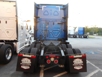 Freightliner Cascadia 126 sleeper truck rear view showing chassis and mud flaps with Peach State 50 Years logos.
