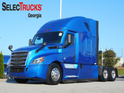 Freightliner Cascadia 126 truck in blue, side view showing cab and wheel details with SelectTrucks Georgia watermark.