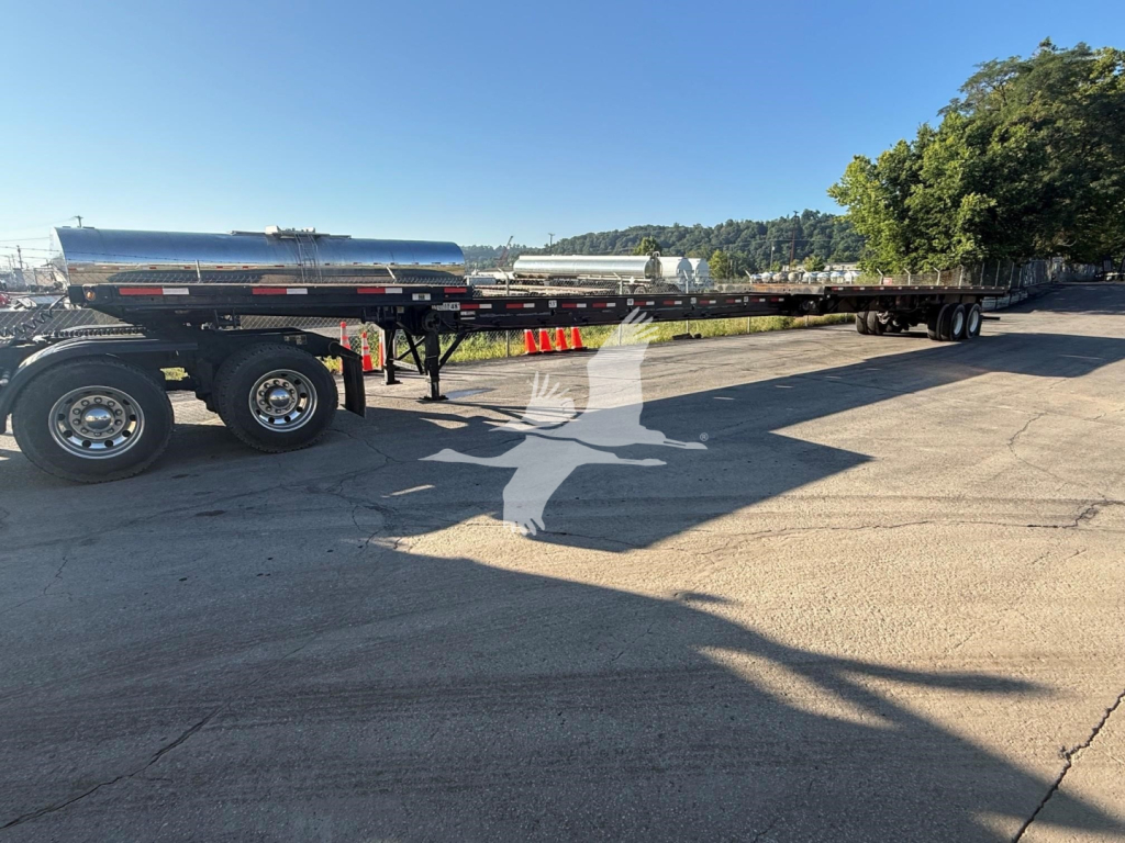 Trailer image showing a long Fontaine flatbed trailer with cylindrical tank on upper deck, dual rear axles, and long chassis. Visible text on trailer includes no legible labels; VIN and stock numbers are in listing not on the image.