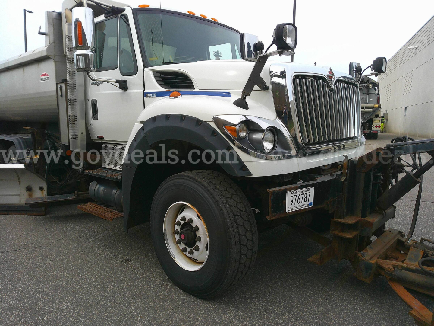 International WorkStar 7600 plow truck side view showing front grille, large bumper, and wheel.
