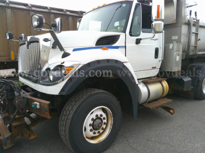 Truck side view showing 2013 International WorkStar 7600 plow truck with front fender, large wheel, and plow mount.