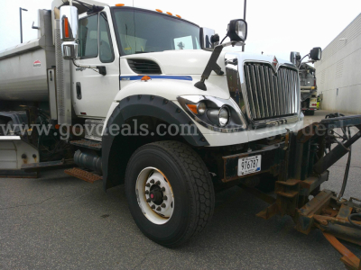 International WorkStar 7600 plow truck side view showing front grille, large bumper, and wheel.