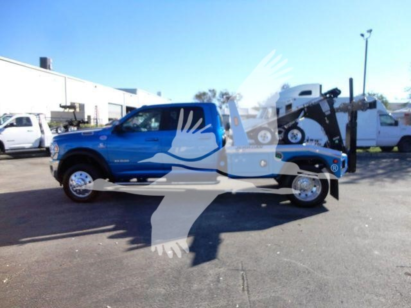 Blue 2024 Ram 5500 SLT pickup truck with crane/tower in bed, side view, stock number J53154, winch category, new condition.