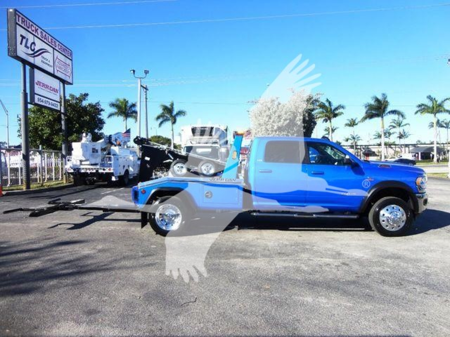 Ram 5500 truck in blue on lot with winch equipment, side profile view
