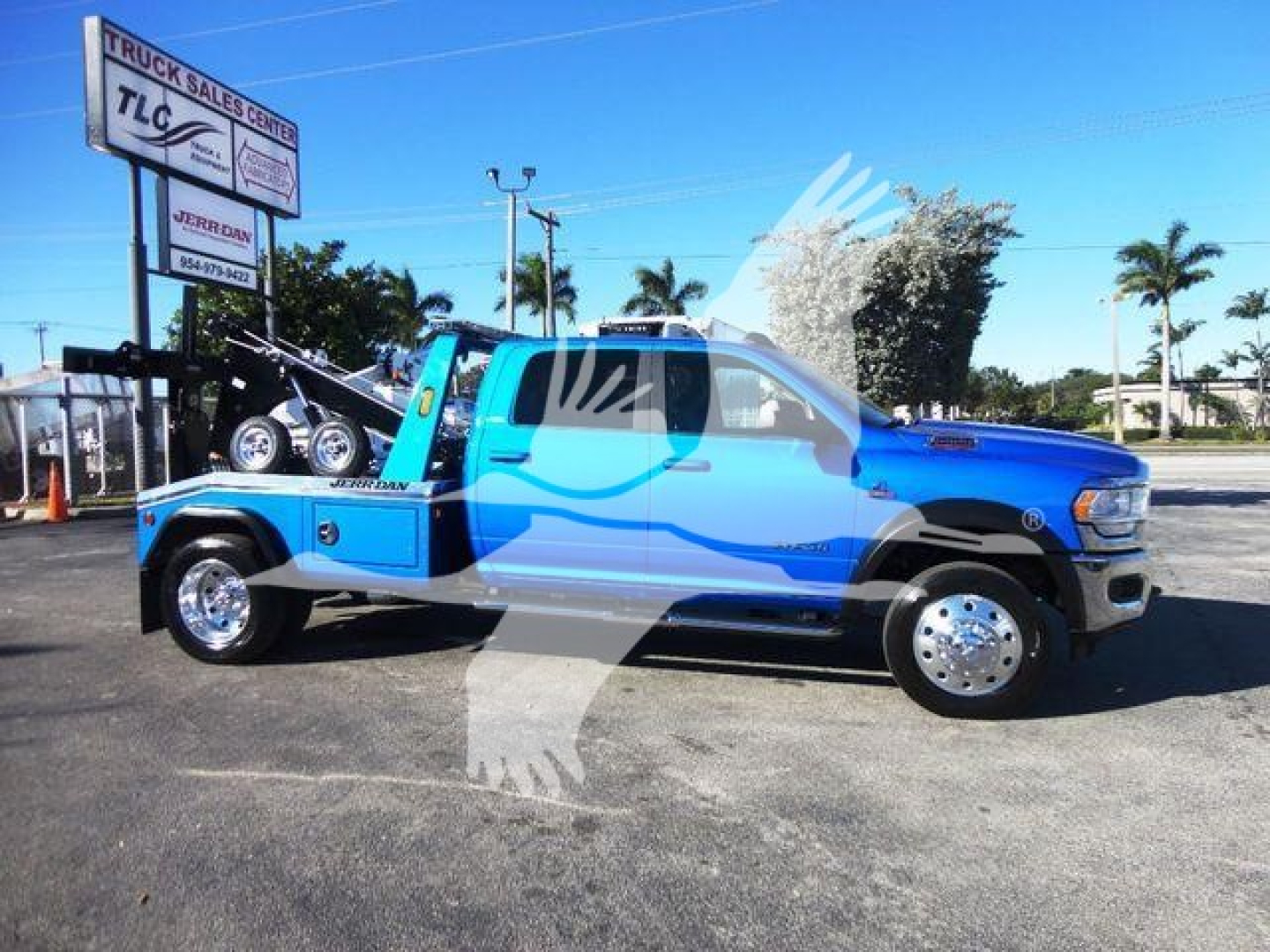 Ram 5500 tow truck side view showing blue truck with chrome wheels and a winch bed. Stock number J53154, category Winch, type Trucks, new vehicle.