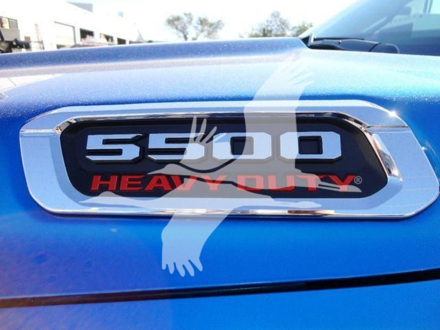 Ram 5500 Heavy Duty badge on blue vehicle hood.