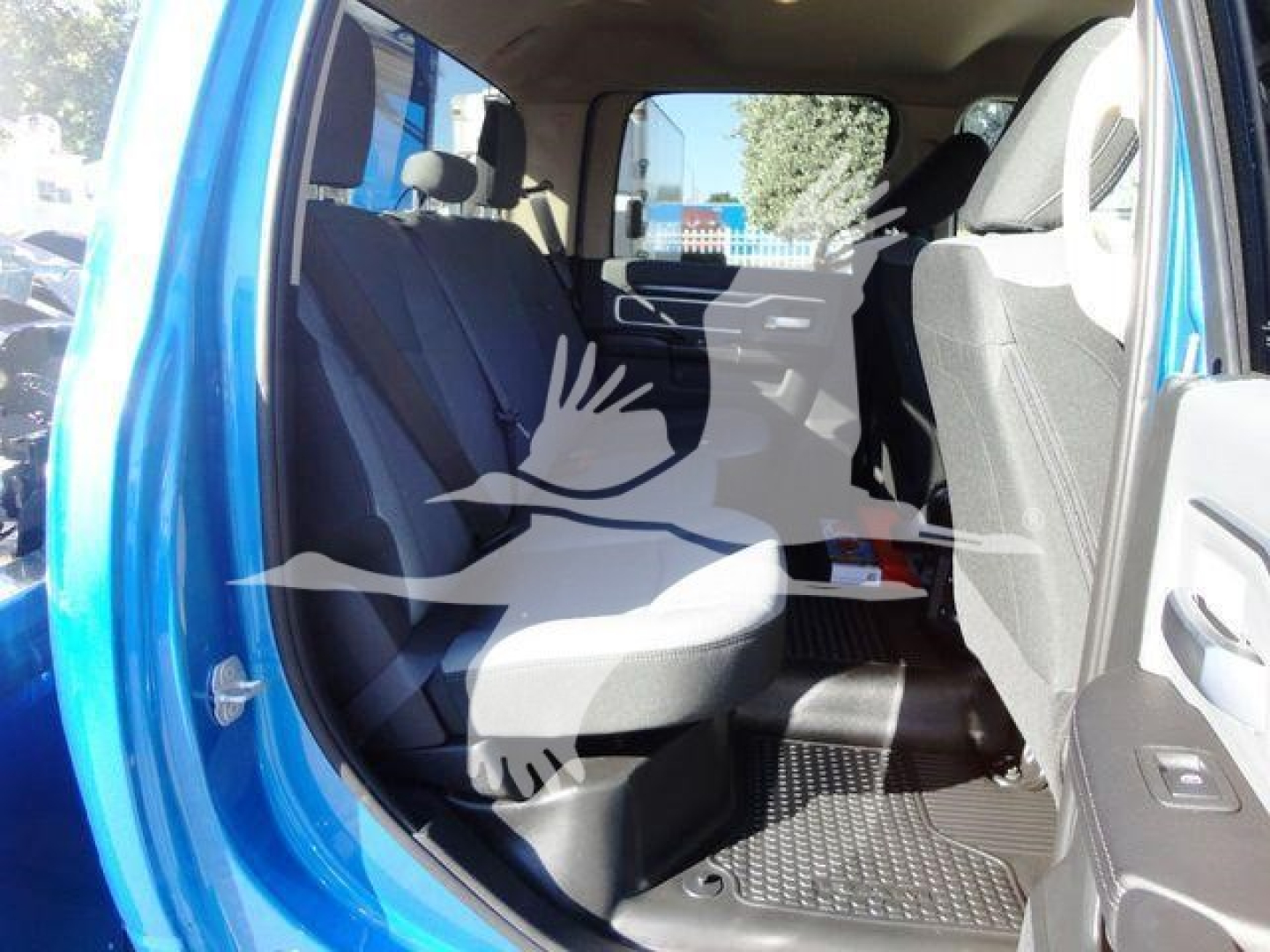 Ram 5500 SLT interior rear passenger area showing seating and door panel. Blue exterior visible at doorway.