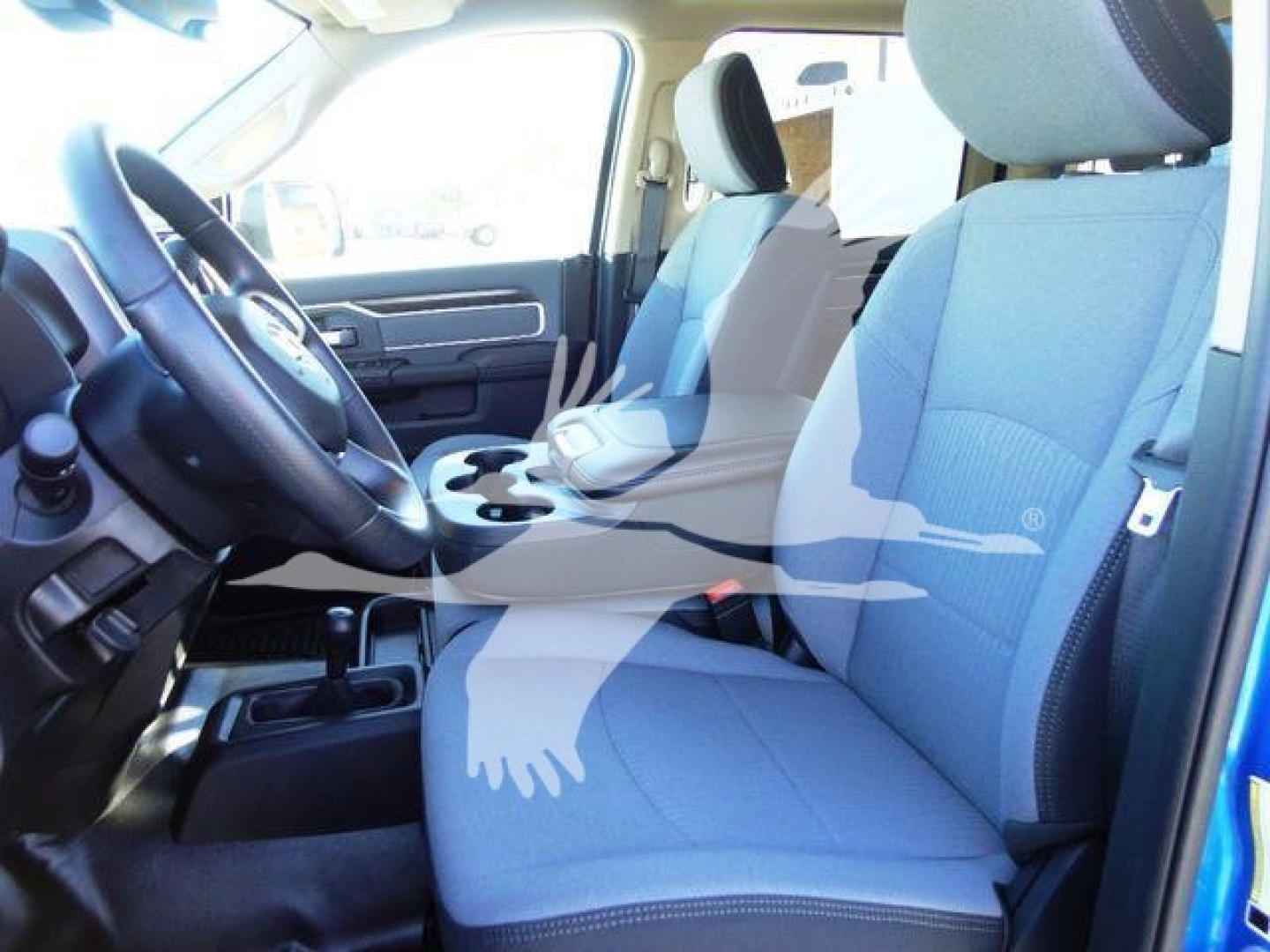 Ram 5500 SLT interior front seats and driver area with center console visible.