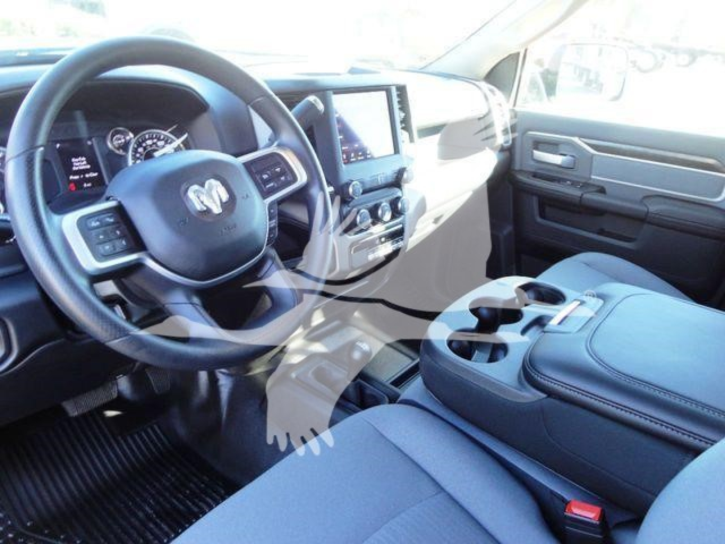 Interior of a 2024 Ram 5500 SLT showing steering wheel with Ram badge, dashboard touchscreen, center console with cupholders, and front seats.