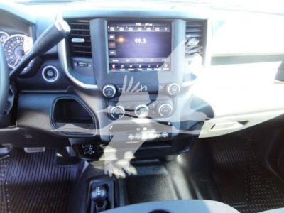 Ram 5500 interior dashboard showing center touchscreen display with radio station 99.3, control knobs, steering wheel, and gear selector area.