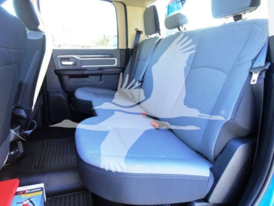 Ram 5500 rear interior showing two-tone cloth seats, rear bench seating, seat belts, and door panel.