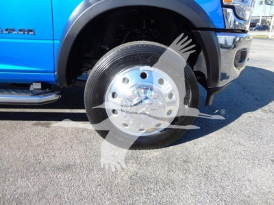 Ram 5500 SLT blue truck front wheel and fender showing wheel and tire and part of side badge