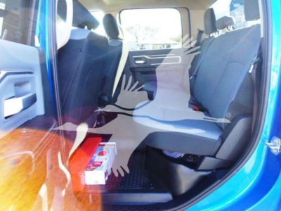 Ram truck interior with front and rear seats visible; blue exterior; some boxes on the floor; no specific model text visible on image.