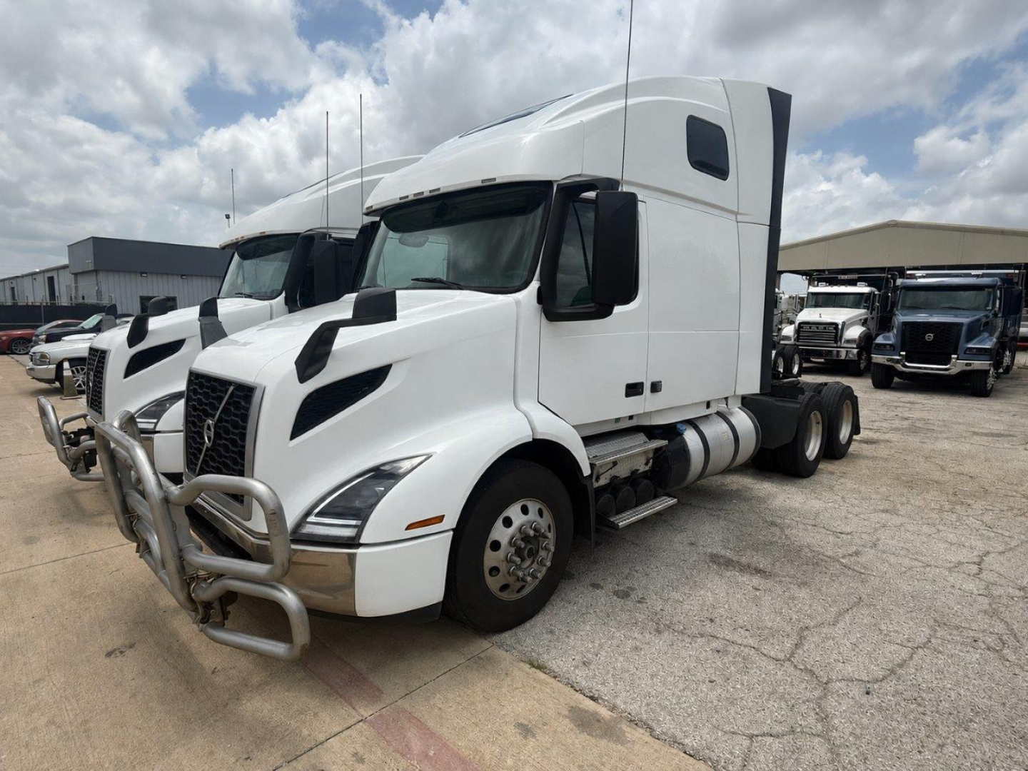 2024 Volvo VNR64T660 sleeper cab truck from the front-left angle, with chrome bull bar and taggable exterior features visible.