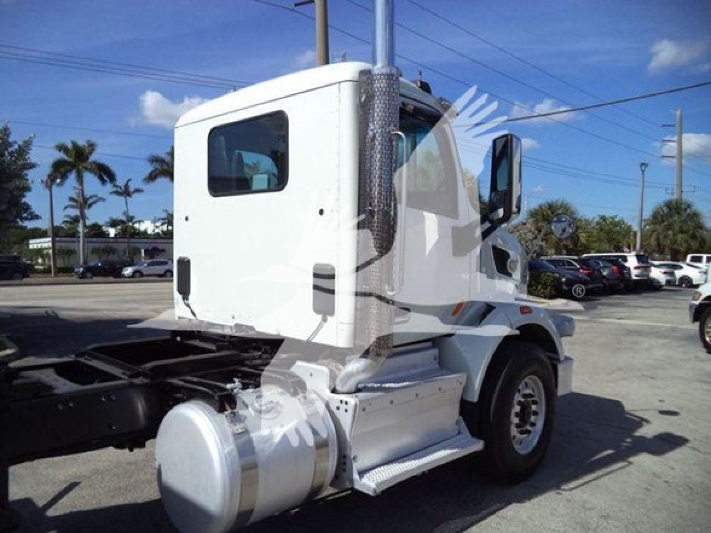 Peterbilt 567 truck cab in white, side view showing fuel tank and step, chassis rear with hitch.