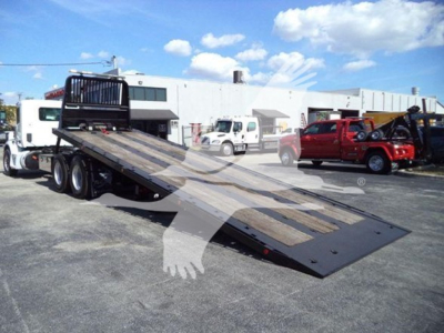 Peterbilt 567 rollback tow truck with hydraulic flatbed in lowered position