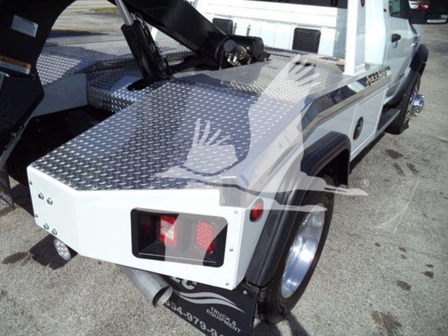 Ram 4500 SLT tow truck/Winch with aluminum diamond plate bed and rear light assembly visible