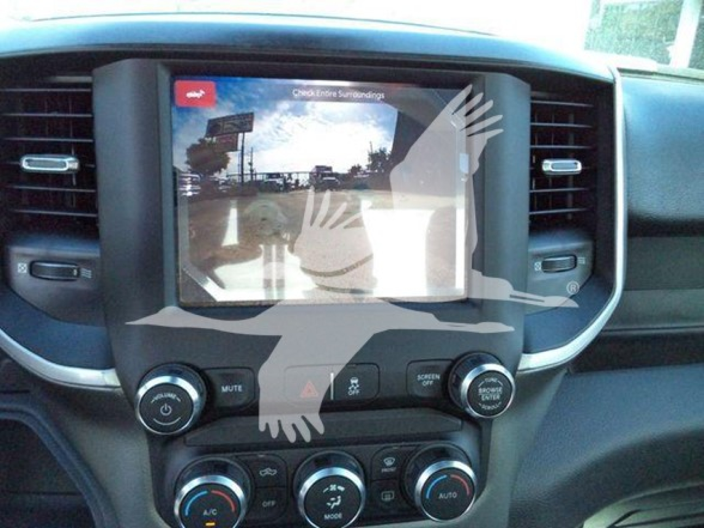 Ram 4500 interior showing center infotainment screen and climate controls. Visible text includes 'Check Entire Surroundings' on screen and various control labels.