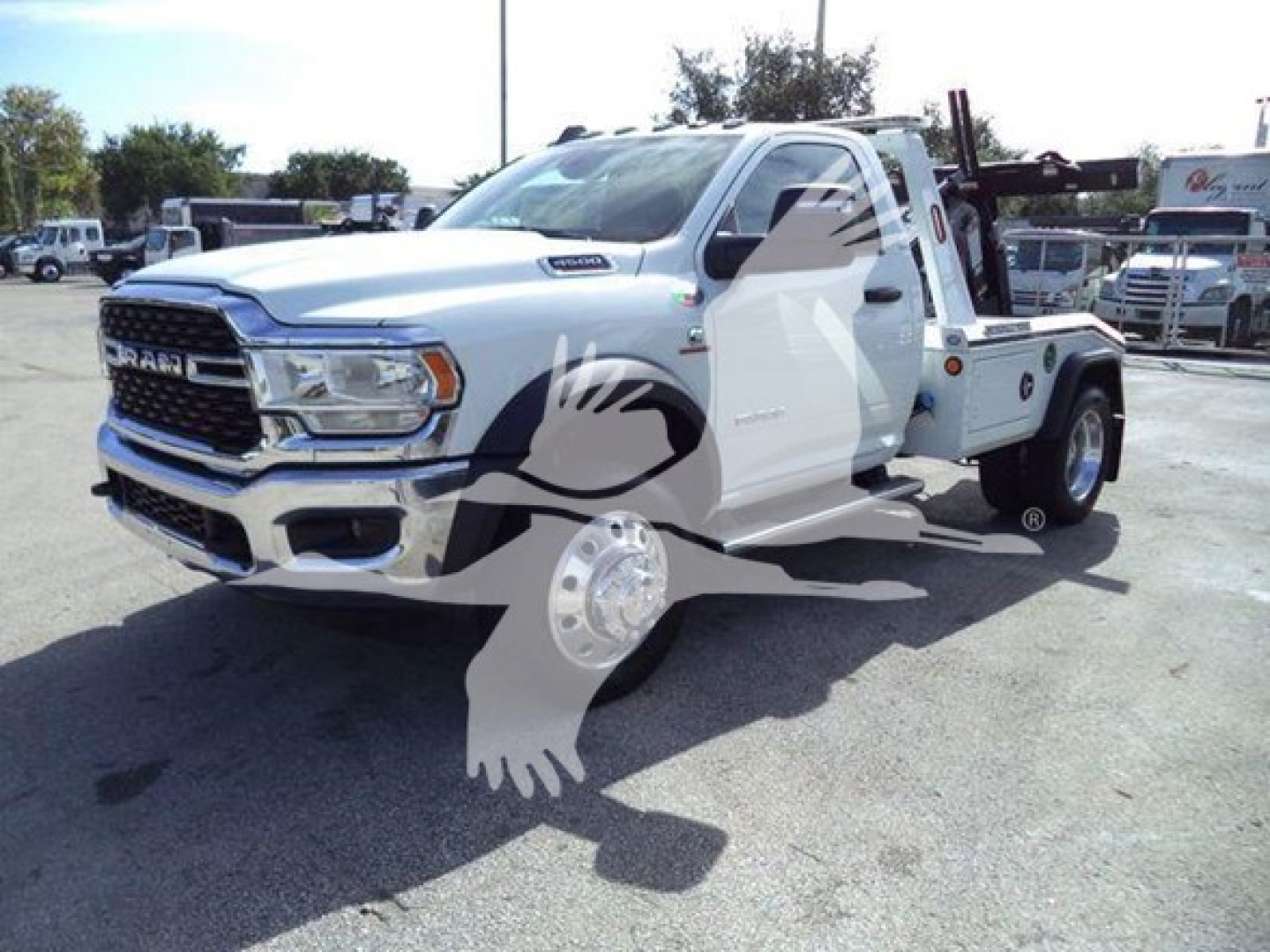 Ram 4500 tow truck with winch setup, white cab, front grille, dual tires, and equipment on bed; VIN tag not visible.