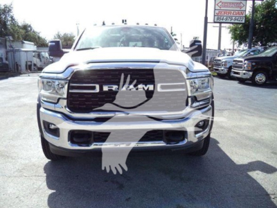 Ram 4500 pickup truck front view showing large grille with RAM letters and bumper, chrome finish, dealership lot in background.