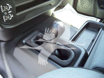 Ram 4500 cabin interior view showing gear shifter in center console and control buttons on left; part of floor mat visible.
