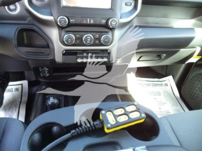 Ram 4500 interior with center console and a handheld remote in cup holder area.