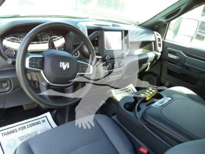 Ram 4500 SLT interior view showing steering wheel with Ram logo, dashboard, center touchscreen, and black leather seats.