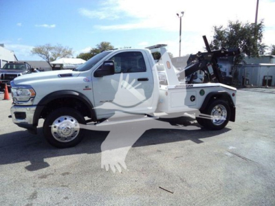 Ram 4500 tow truck with winch. Side view shows decal and equipment; no legible labels visible beyond generic truck features.
