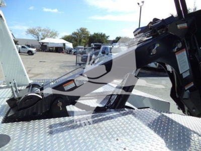 Trucks and Winch equipment in a dealership lot showing a Ram 4500 winch setup with metal diamond-plate surface and control area.