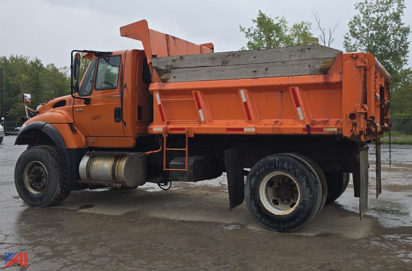 Orange International WorkStar 7600 dump truck side view showing cargo bed and dual rear wheels.