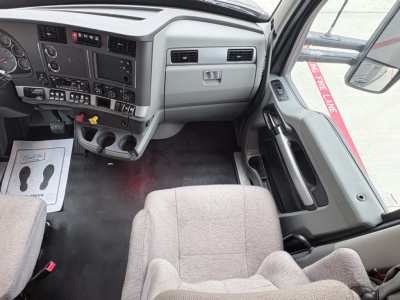 Kenworth T680 van interior dashboard and front passenger seat view showing instrument cluster and center console.