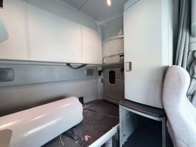 Kenworth T680 sleeper cab interior cargo area showing storage cabinets and sleeper area
