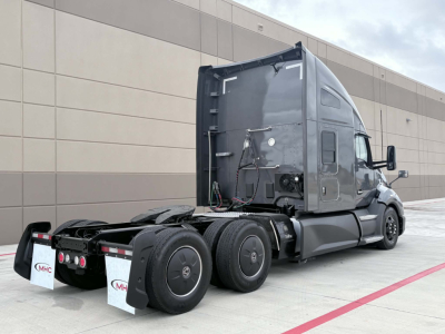 Kenworth T680 tractor cab rear/side view showing fifth wheel area and rear tires.