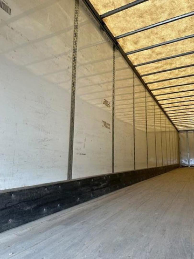 Interior of a 2016 Wabash van trailer showing long empty cargo area with white sidewalls and overhead framing.