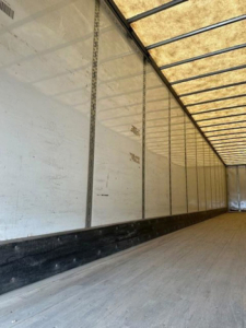 Interior of a 2016 Wabash van trailer showing long empty cargo area with white sidewalls and overhead framing.