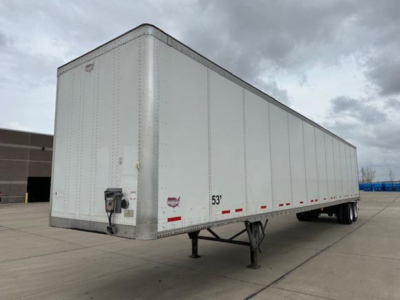 Trailer side view showing a 53' white Wabash van with front hitch and landing gear.