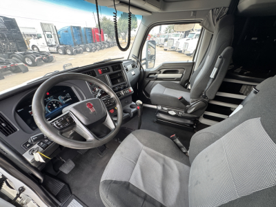 Kenworth T680 truck cab interior view showing steering wheel, dashboard, driver seat, and center console.