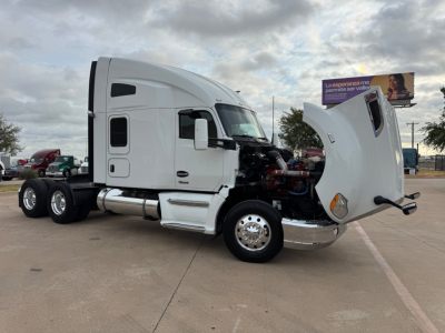 Kenworth T680 conventional sleeper truck with hood open showing engine area and side view mirrors.