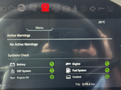 Kenworth T680 dashboard screen showing active systems: Battery, Engine, DEF System, Engine Oil, Fuel System, Coolant with green check marks; Menu with activeWarnings and No Active Warnings text; temperature 29°C.