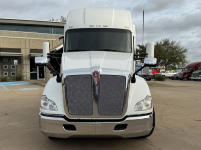 Kenworth T680 front view showing large dual grille and windshield, chrome bumper, and large side mirrors.