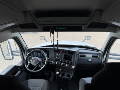 Kenworth truck interior dashboard and steering wheel cockpit view.