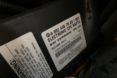 Label on engine compartment showing VIN and sticker with Elec Tronic NAFTA code, date, and Continental? sticker.