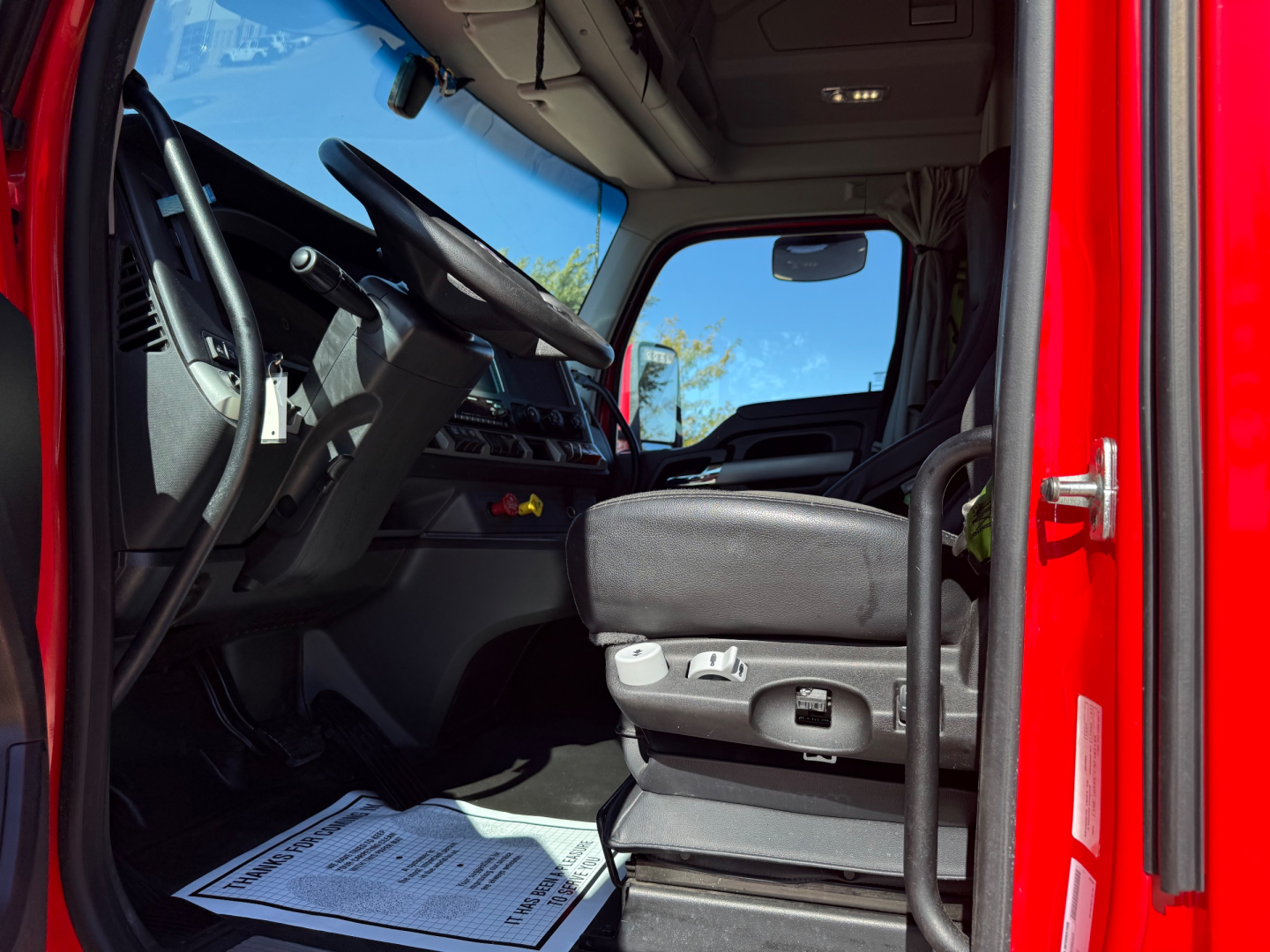 Kenworth T680 truck cab interior showing driver's seat and dashboard in view.